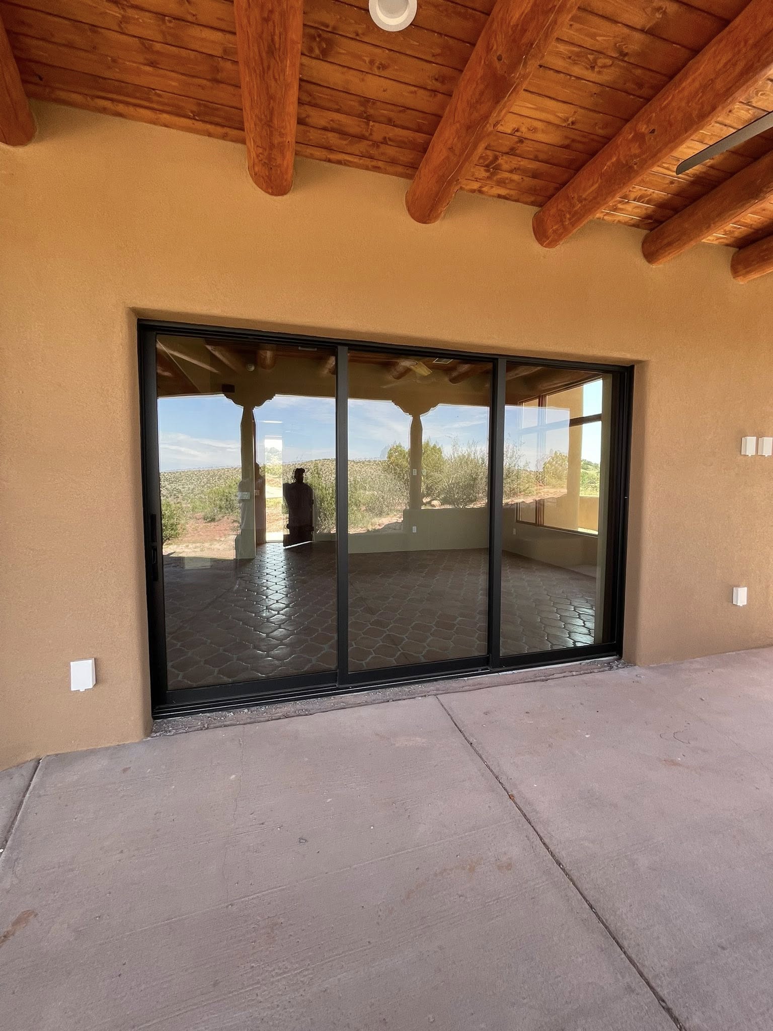 3-panel sliding glass door on adobe home